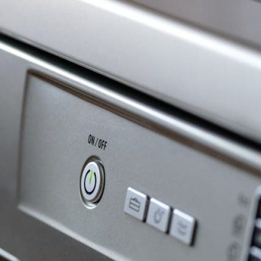 Close-up view of modern stainless steel kitchen appliances with focus on dishwasher and oven.